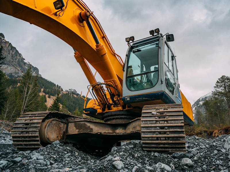 Tracked excavator carrying out earthwork on an industrial construction site